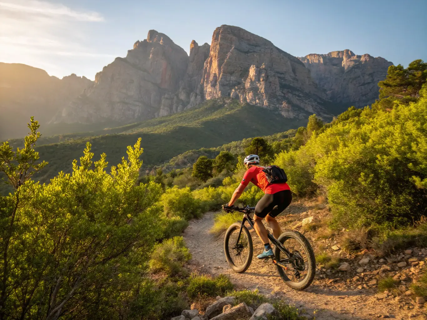 A mountain biker skillfully navigating a rocky and steep mountain trail, demonstrating an advanced-level ride.